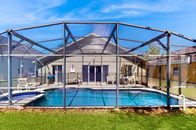 a view of a chairs and table in the backyard