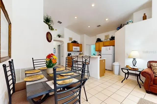 a dining room with furniture and a window