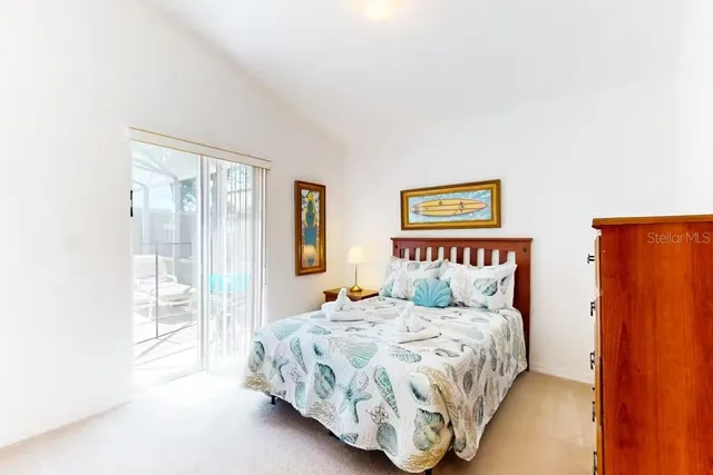 a bedroom with a large bed and a large window