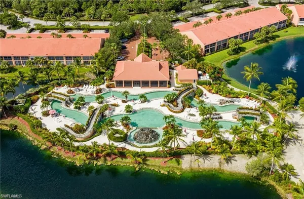 an aerial view of residential houses with outdoor space and swimming pool