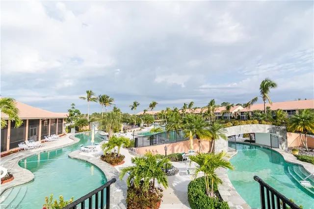 a swimming pool view with a outdoor seating