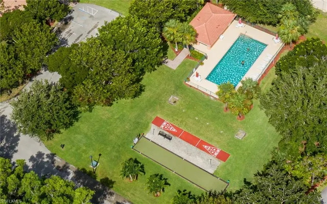 a view of a house with backyard and sitting area