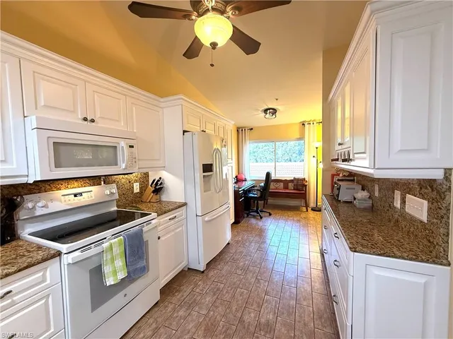 a kitchen with a stove a sink and a refrigerator