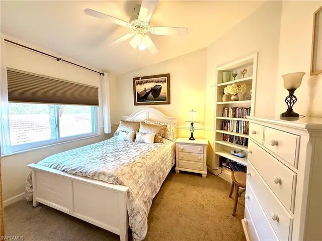 a bed room with a bed and a dresser