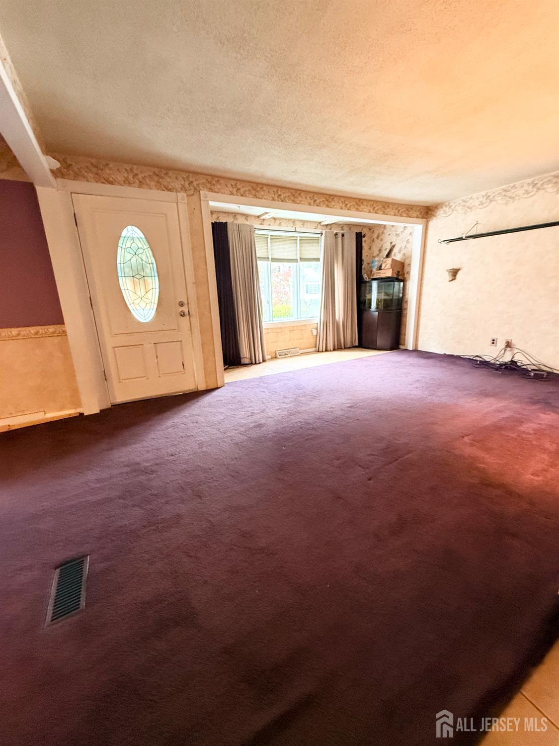 16 Marsad Drive Old Bridge, NJ 08857 - Photo 8 of 18 a view of an empty room with a window and kitchen view