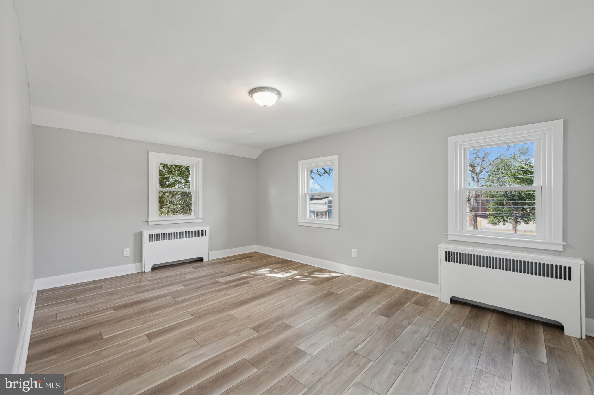 1230 MacDade Boulevard Woodlyn, PA 19094 - Photo 11 of 16 a view of an empty room with a window and wooden floor