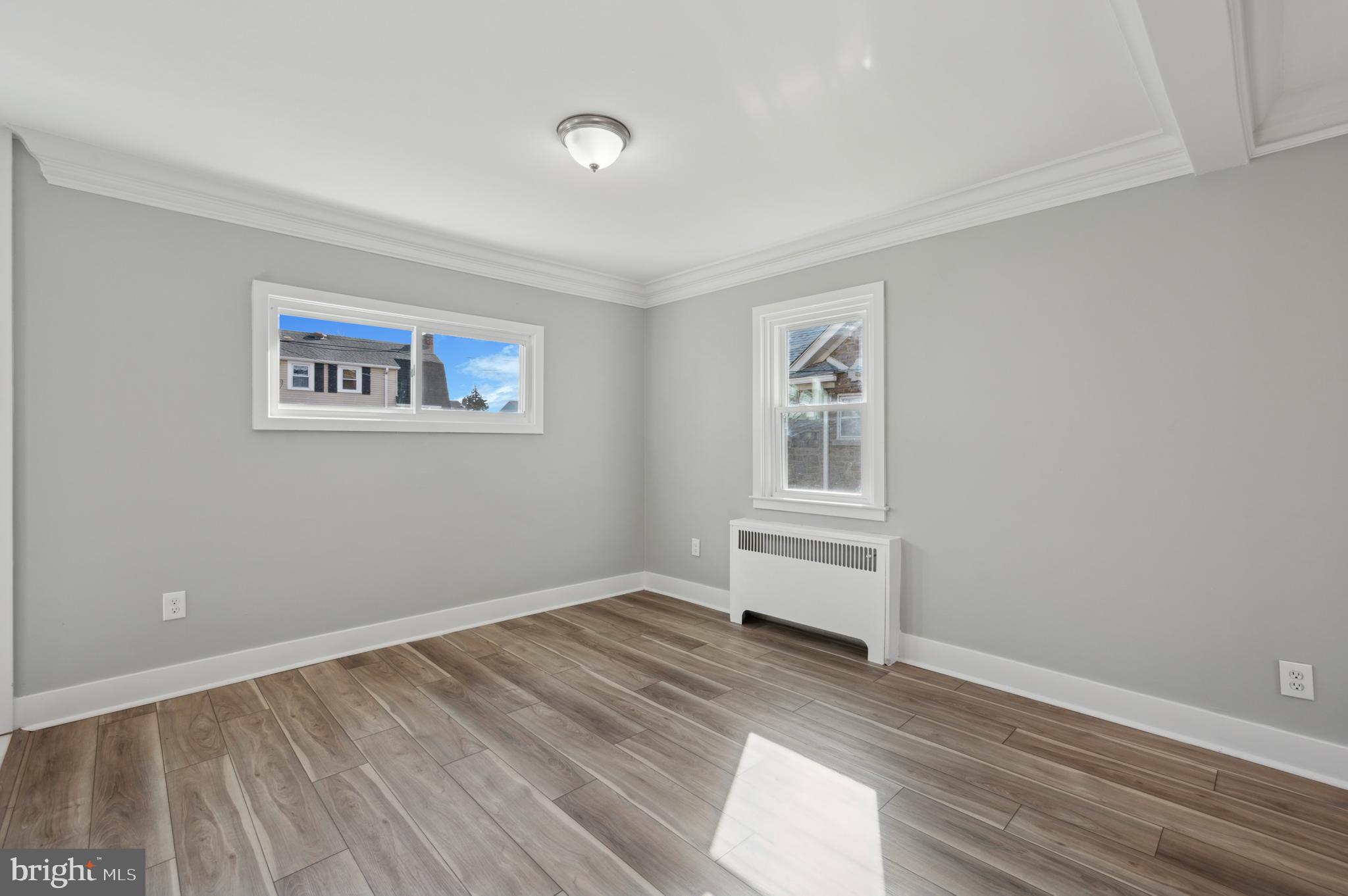 1230 MacDade Boulevard Woodlyn, PA 19094 - Photo 5 of 16 a view of room with window and wooden floor