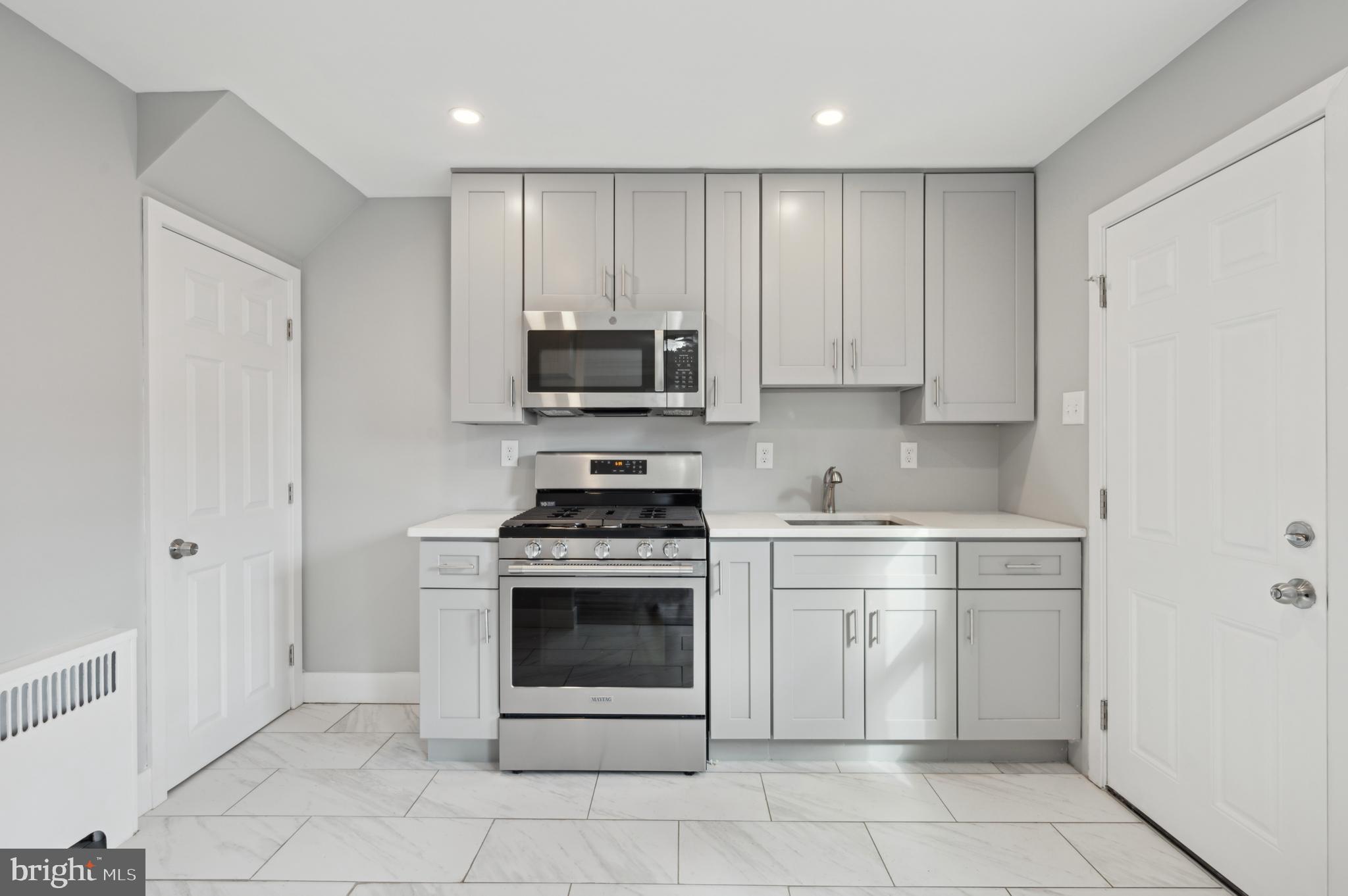 1230 MacDade Boulevard Woodlyn, PA 19094 - Photo 8 of 16 a kitchen with cabinets stainless steel appliances and a sink