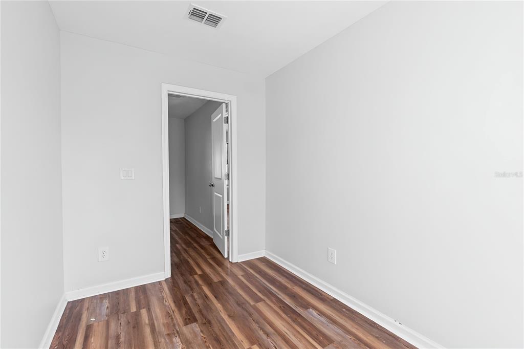17380 Northwest Green Acres Road Bristol, FL 32321 - Photo 16 of 35 a view of a hallway with wooden floor