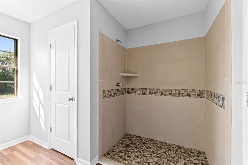 17380 Northwest Green Acres Road Bristol, FL 32321 - Photo 22 of 35 a bathroom with a shower