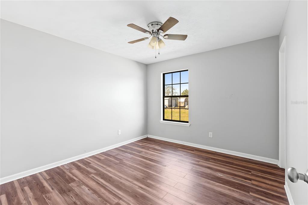 17380 Northwest Green Acres Road Bristol, FL 32321 - Photo 26 of 35 wooden floor in an empty room with a window