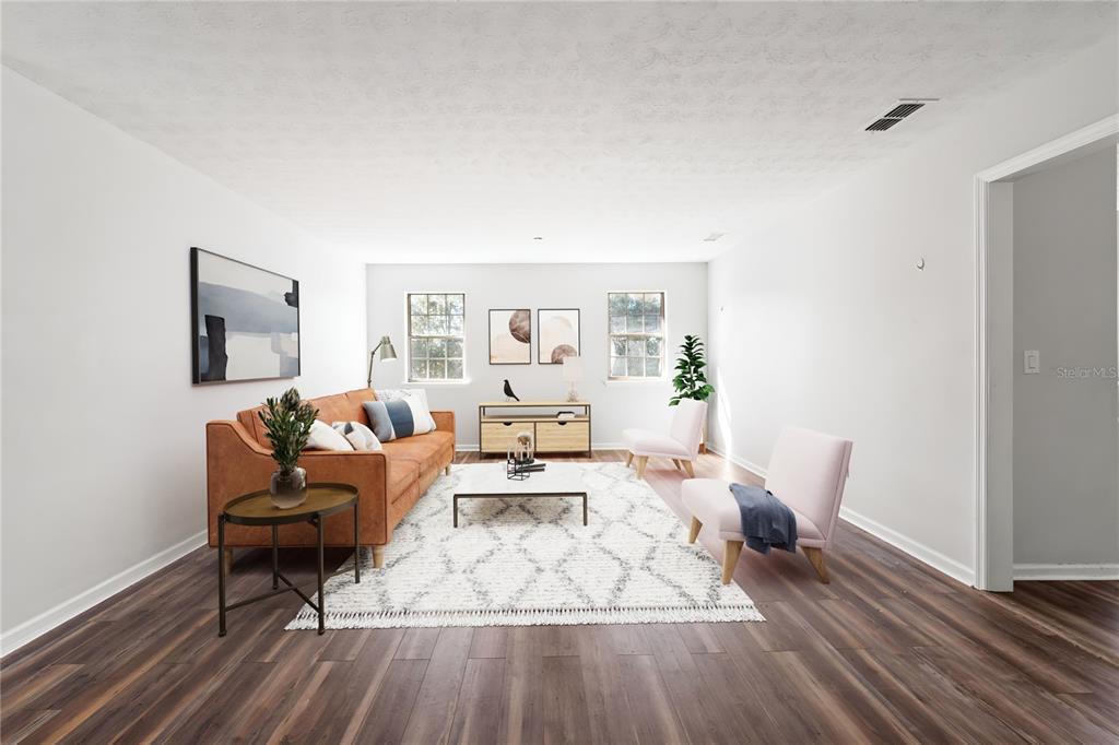 17380 Northwest Green Acres Road Bristol, FL 32321 - Photo 6 of 35 a living room with furniture and wooden floor