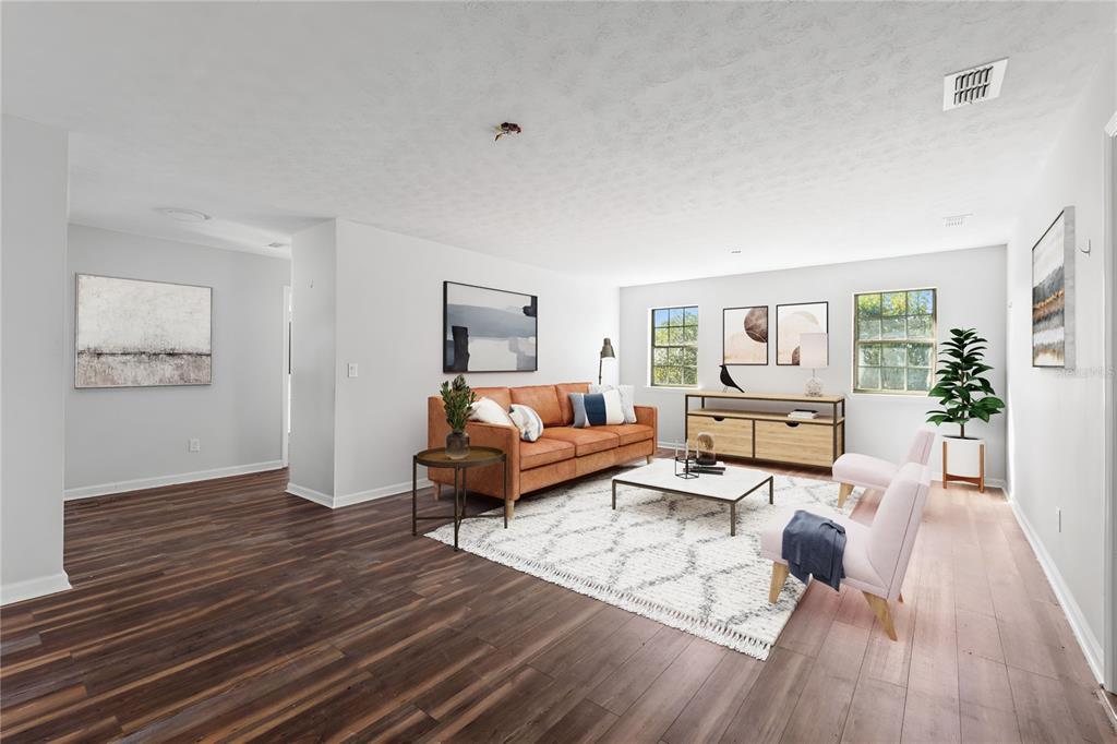 17380 Northwest Green Acres Road Bristol, FL 32321 - Photo 8 of 35 a living room with furniture and a wooden floor