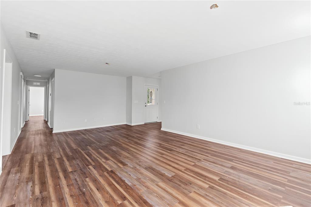 17380 Northwest Green Acres Road Bristol, FL 32321 - Photo 10 of 35 a view of empty room with wooden floor