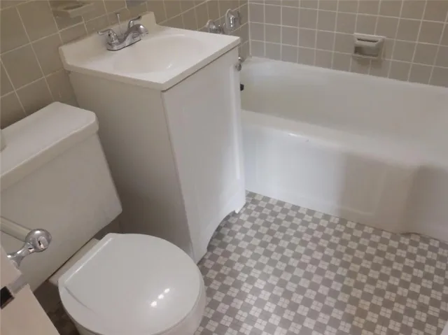 a bathroom with a sink a toilet and bathtub