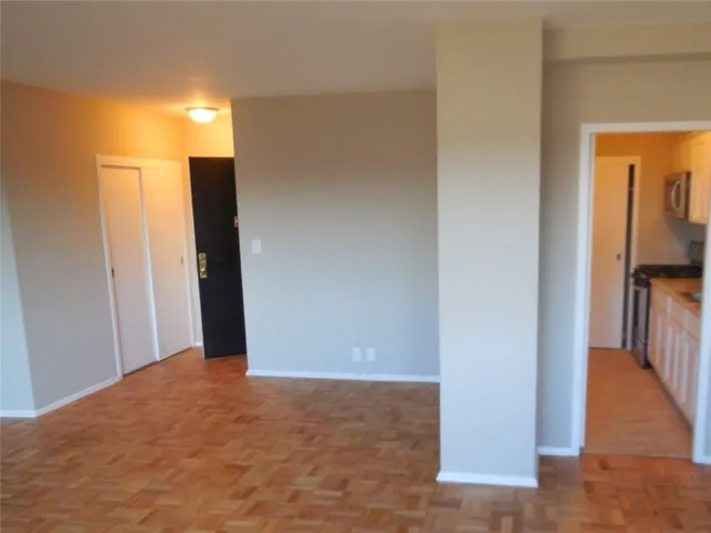 a view of hallway with wooden floor