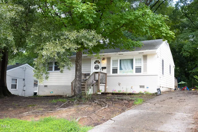 a view of a white house with a yard