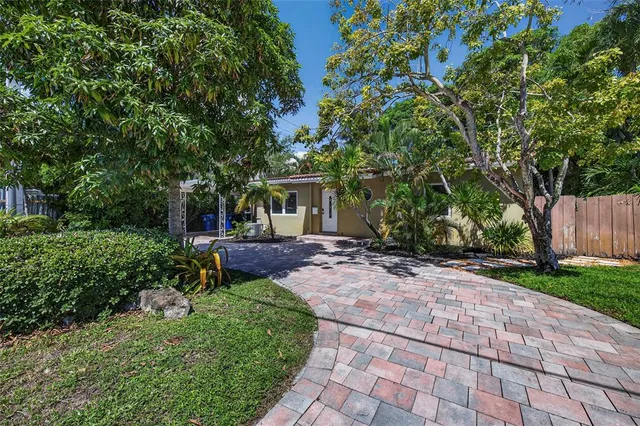 a view of a patio with table and chairs a barbeque and a large trees