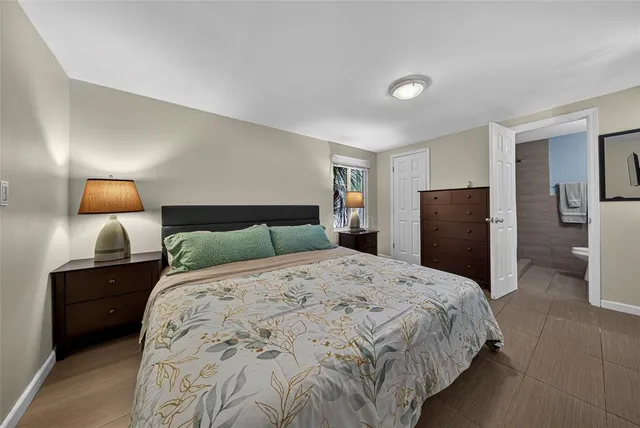 a bedroom with a bed and cabinet