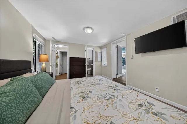 a bedroom with a bed and a flat screen tv