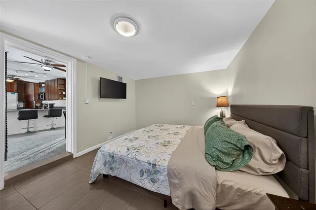 a bedroom with a bed and a mirror