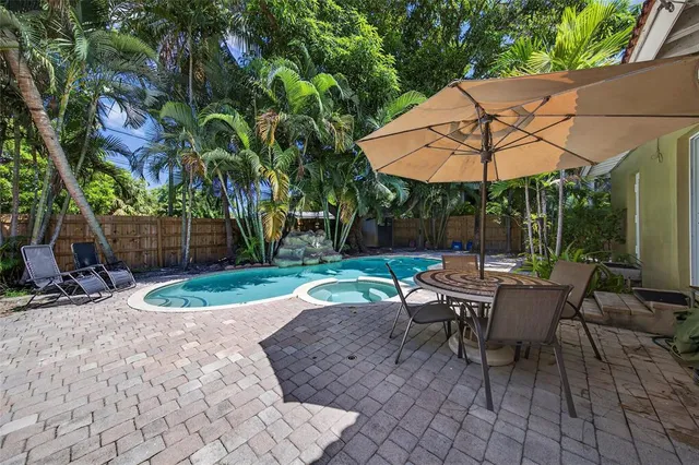 a view of backyard with outdoor seating and trees