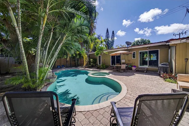 a view of a swimming pool with chairs