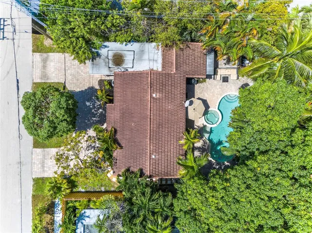 view of a house with a yard and a garden