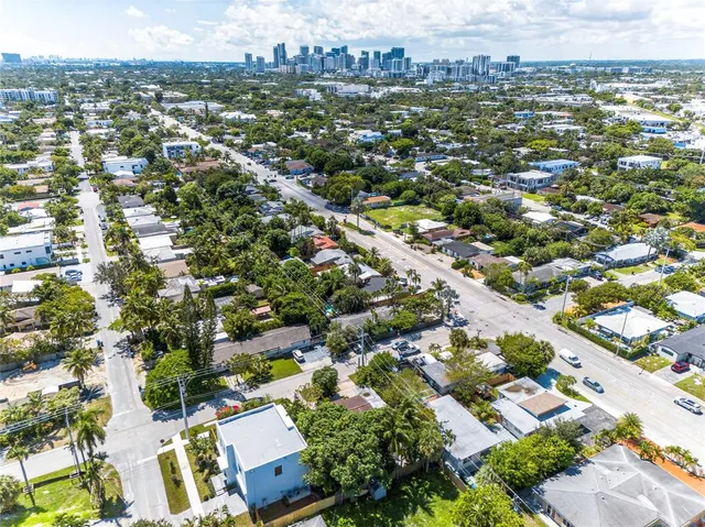 an aerial view of residential houses with city view