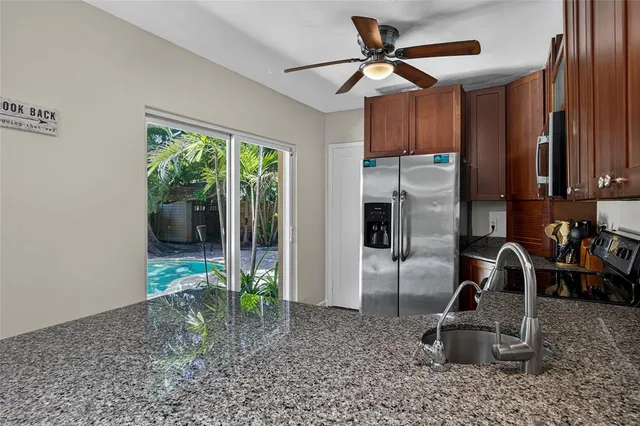 a kitchen with refrigerator and window