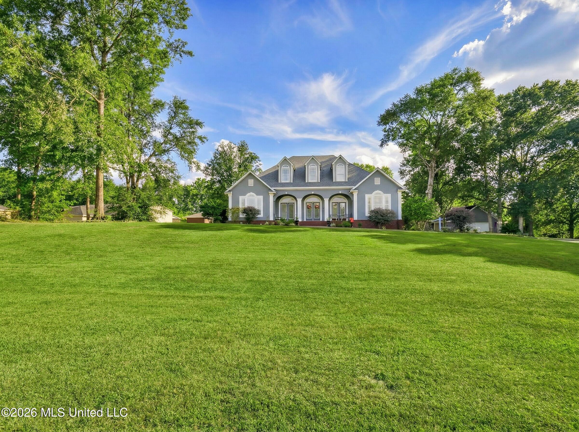 5402 Huckleberry Lane Moss Point, MS 39562 - Photo 2 of 63 make_front_yard_and_trees_gree_Nano_Bana
