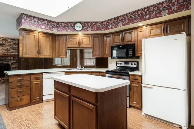 a kitchen with a sink stove and refrigerator
