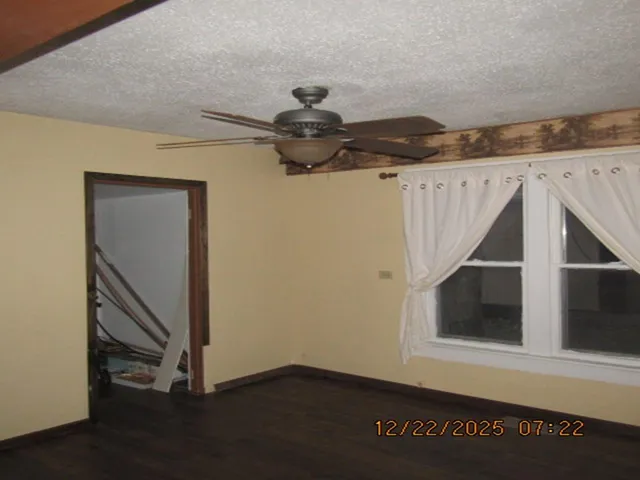 a view of a dining room with furniture and wall clock