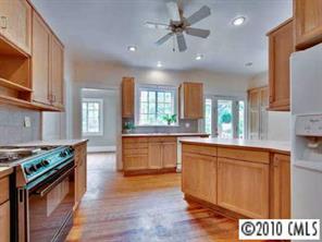 2143 Norton Road Charlotte, NC 28207 - Photo 5 of 8 a kitchen with stainless steel appliances granite countertop a stove a sink dishwasher and a refrigerator with wooden floor
