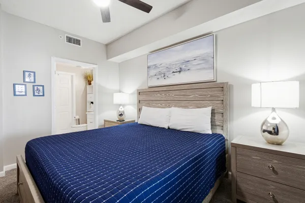 a bedroom with a bed and painting on the wall