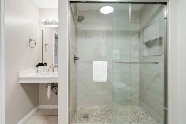 a bathroom with a shower and a sink