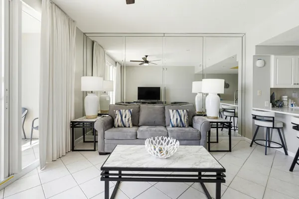 a living room with furniture and a chandelier