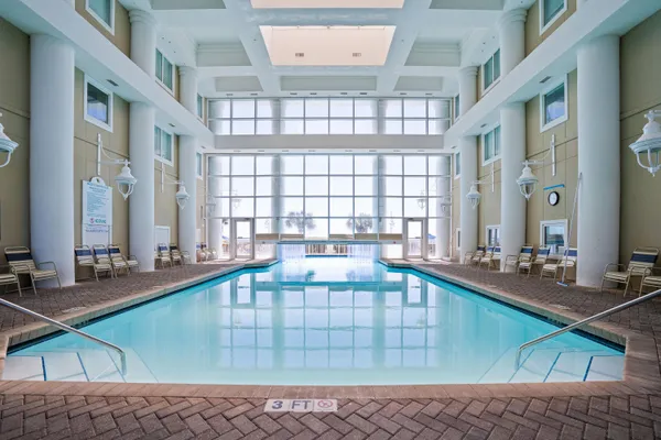 a swimming pool with outdoor seating and yard