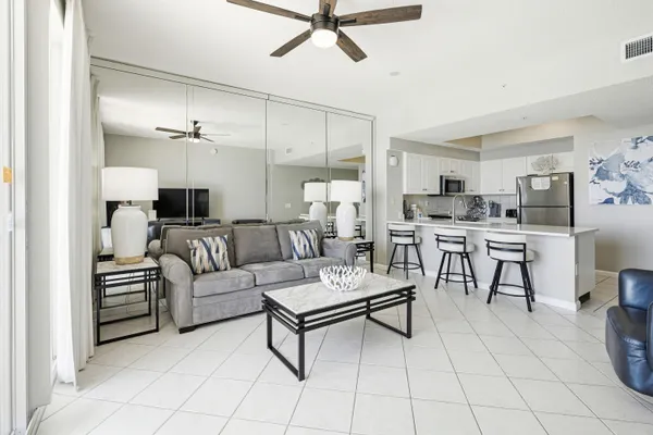 a living room with furniture and kitchen view