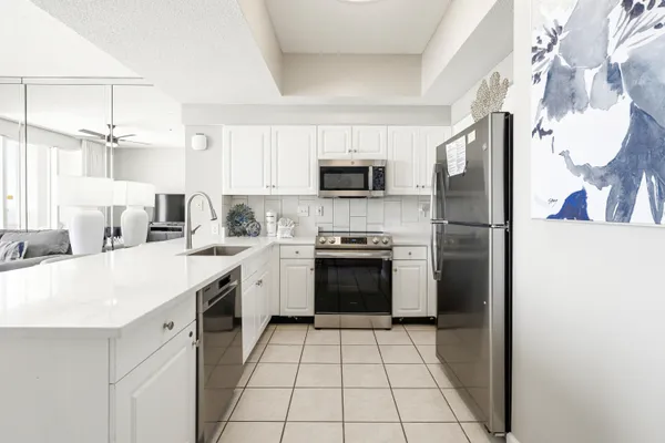 a kitchen with a stove a sink and a refrigerator
