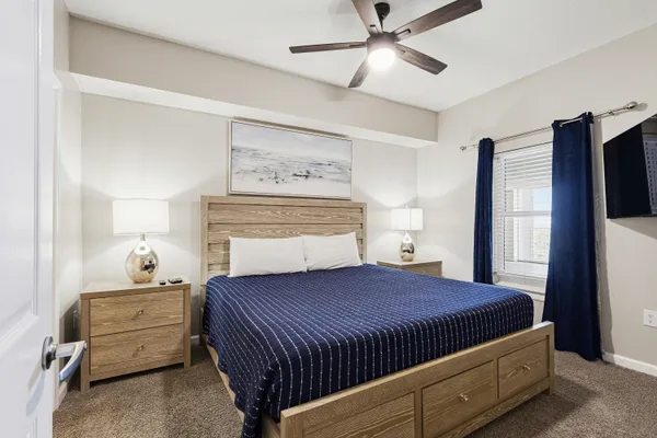 a bedroom with a bed and a chandelier