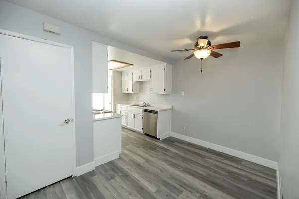 a view of a kitchen with a microwave and a ceiling fan