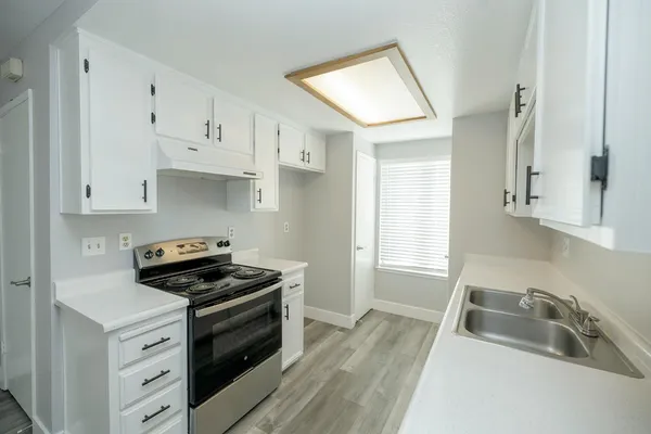 a kitchen that has a sink and a stove