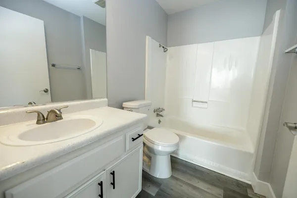 a white bath tub sitting next to a white toilet