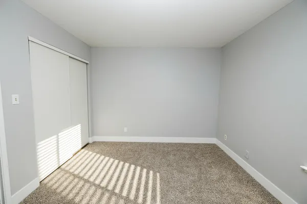 a view of walk in closet with empty racks