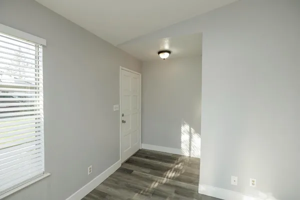 a view of an empty room and a window