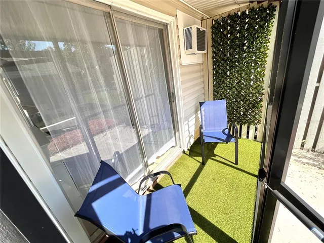 a view of a room with furniture and a window