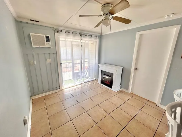 a view of a livingroom with a fireplace and a window