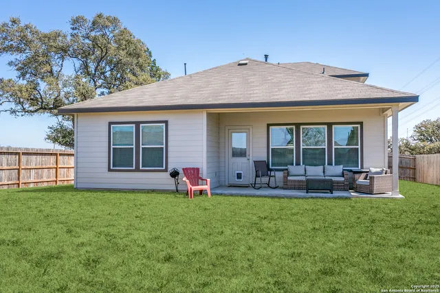 a front view of house with yard and seating space