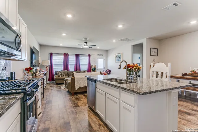 a kitchen with stainless steel appliances granite countertop a lot of counter space and a sink